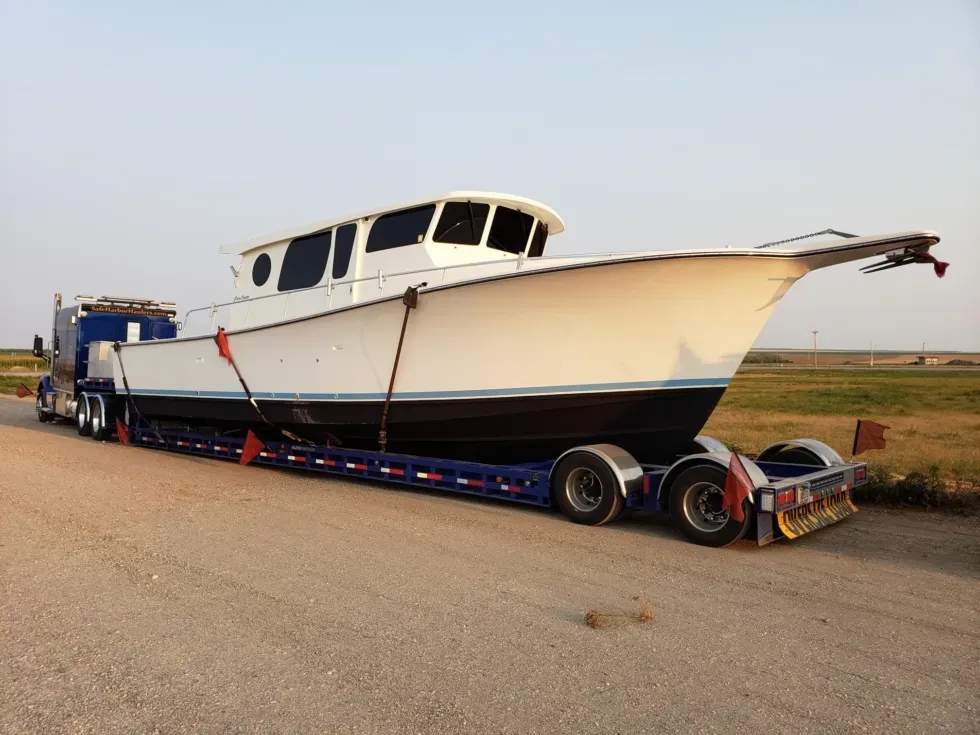 Henriques Maine Coaster 42 yacht secured on a custom lowboy trailer for overland transportation.