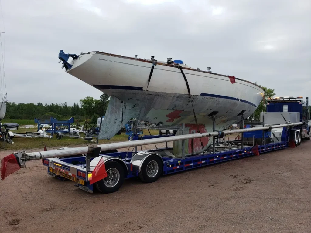 The mast and boom of the 1972 Swan 43 sailboat secured onto the transport trailer.