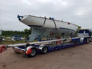 The mast and boom of the 1972 Swan 43 sailboat secured onto the transport trailer.